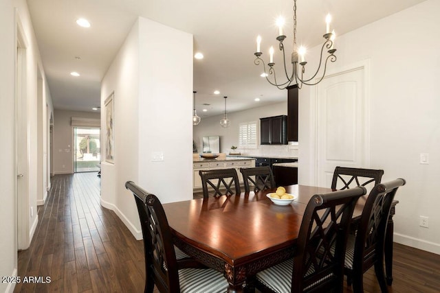 dining area with a notable chandelier and dark wood-type flooring
