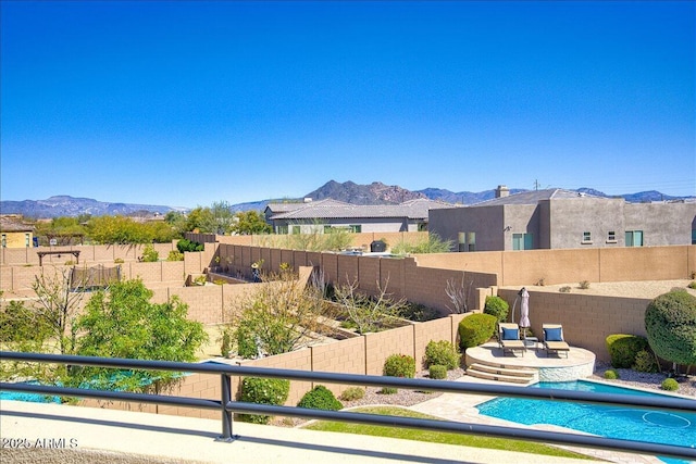 view of swimming pool with a mountain view and a patio