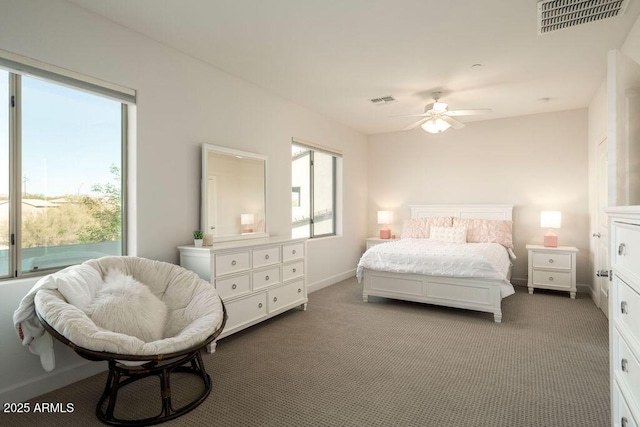 bedroom with ceiling fan and dark carpet