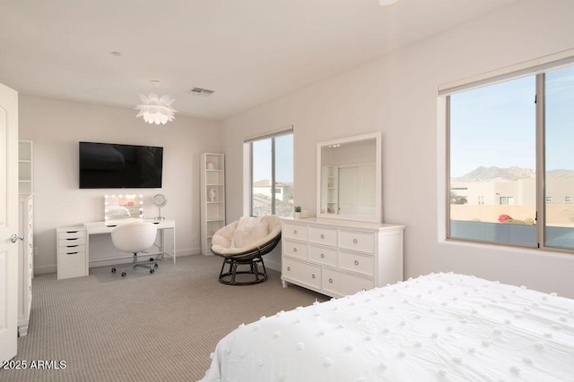 carpeted bedroom featuring a mountain view and an inviting chandelier
