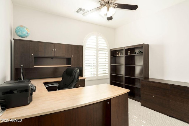 carpeted home office with ceiling fan