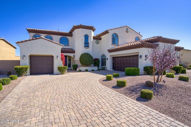 mediterranean / spanish-style house featuring a garage