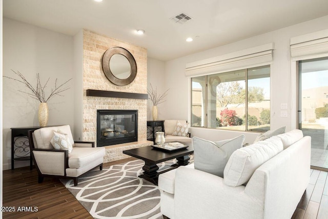 living room with dark hardwood / wood-style floors and a fireplace