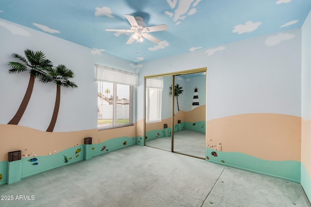 unfurnished bedroom with carpet floors, a closet, and a ceiling fan