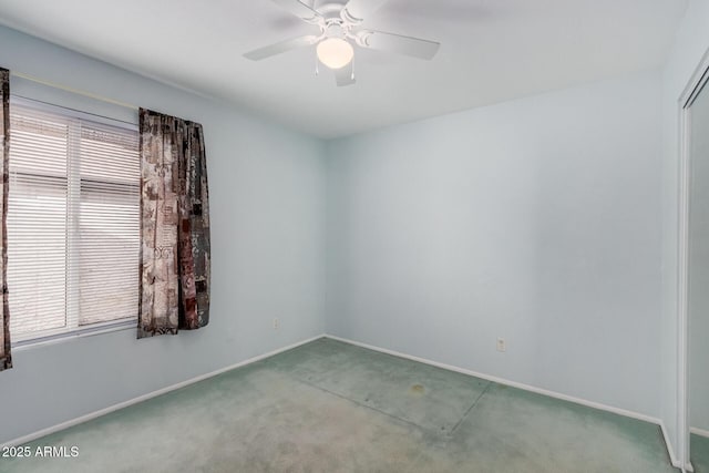 empty room featuring carpet floors, baseboards, and a ceiling fan