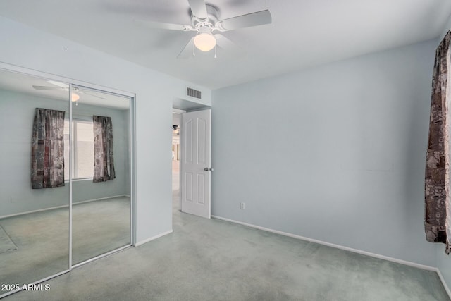 unfurnished bedroom featuring a closet, carpet floors, ceiling fan, and baseboards