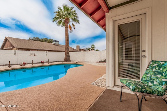 view of swimming pool with a patio, a fenced backyard, and a diving board