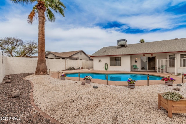 view of pool with a fenced backyard, a patio, and central air condition unit