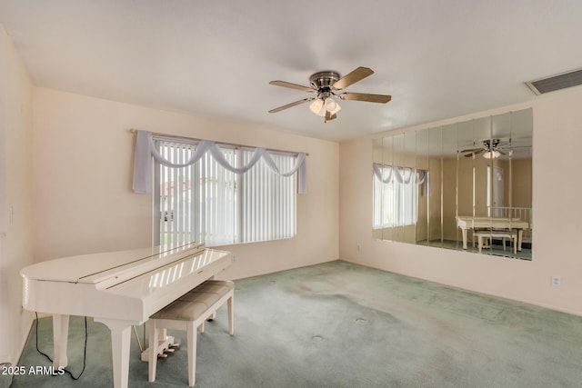unfurnished dining area featuring a ceiling fan and carpet floors
