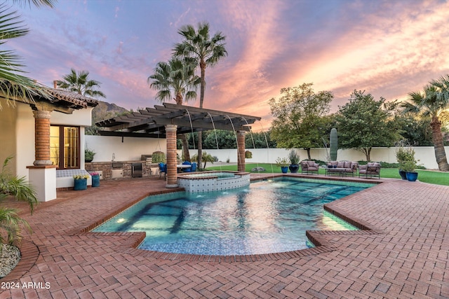 pool at dusk with an in ground hot tub, a pergola, and a patio