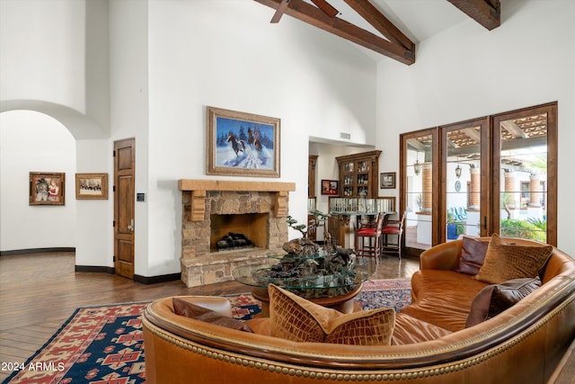 living room with beamed ceiling, a fireplace, high vaulted ceiling, and dark wood-type flooring