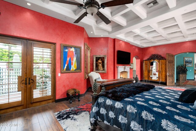 bedroom with beamed ceiling, french doors, dark hardwood / wood-style flooring, coffered ceiling, and ceiling fan