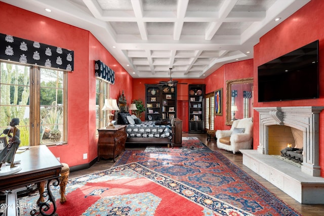 interior space featuring coffered ceiling, dark hardwood / wood-style flooring, beam ceiling, and ceiling fan