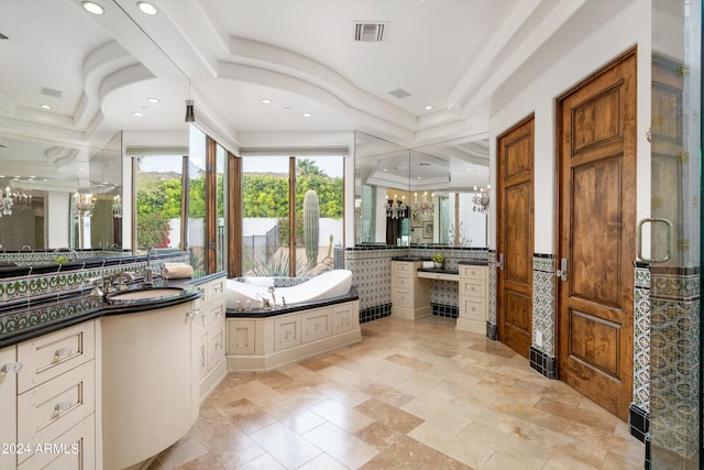 bathroom featuring tile floors, vanity, a tub, and a chandelier