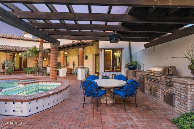 view of patio with a grill, an outdoor kitchen, sink, and a pergola