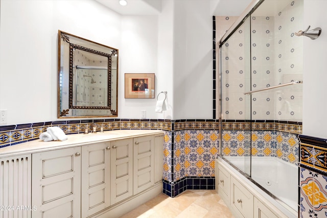 bathroom with tile walls, vanity, tile floors, and backsplash