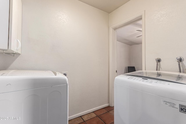 laundry room with washing machine and clothes dryer, tile patterned flooring, baseboards, and cabinet space
