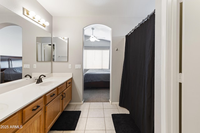 ensuite bathroom with tile patterned floors, ensuite bathroom, a sink, double vanity, and ceiling fan