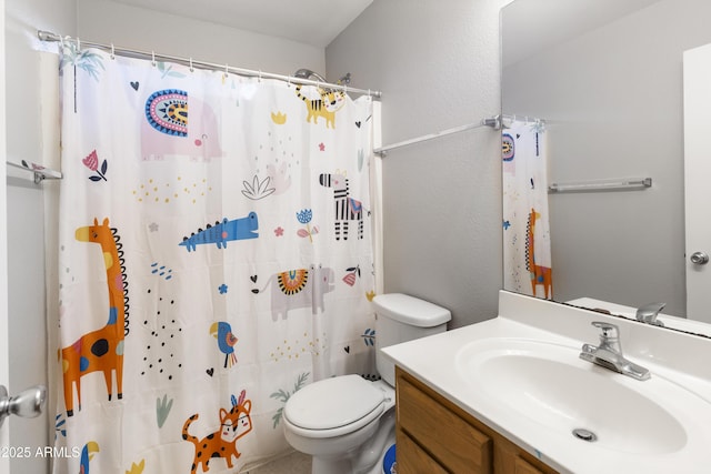 bathroom featuring vanity, toilet, and a shower with curtain