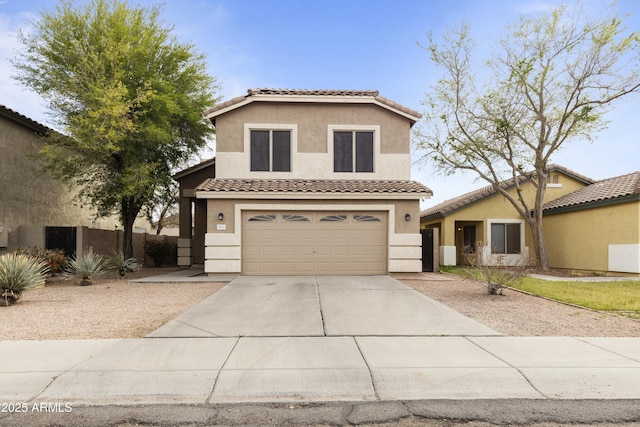 view of front of property with stucco siding, driveway, an attached garage, and a tile roof