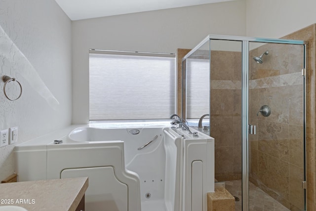 bathroom with vanity, lofted ceiling, and independent shower and bath