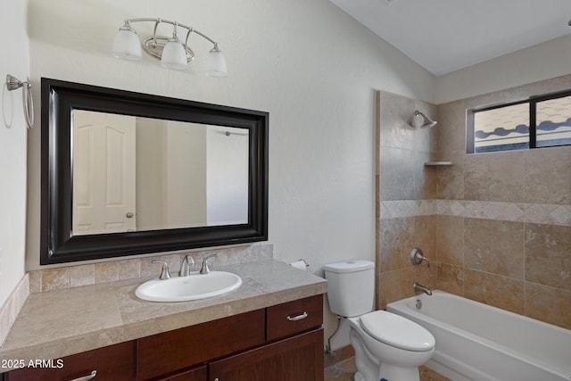 full bathroom featuring tiled shower / bath combo, vanity, toilet, and vaulted ceiling