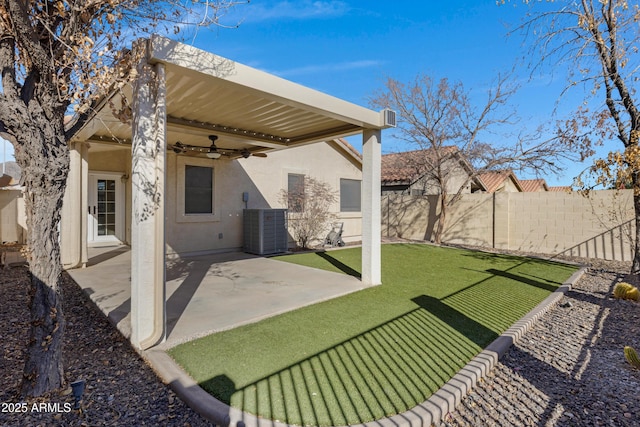 view of yard with ceiling fan, a patio, and central AC unit