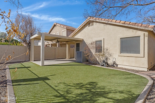 back of property featuring a patio area, cooling unit, and a yard