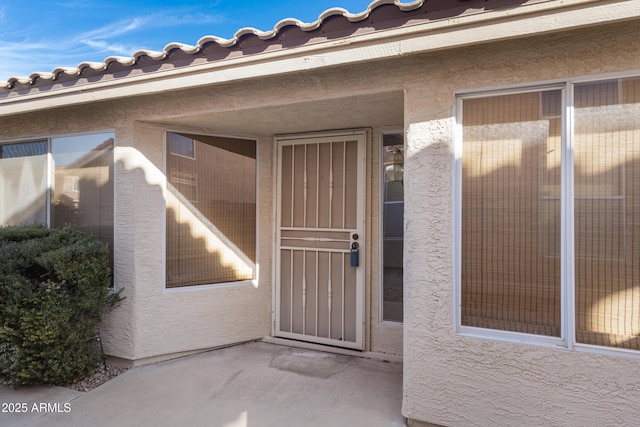 entrance to property with a patio area