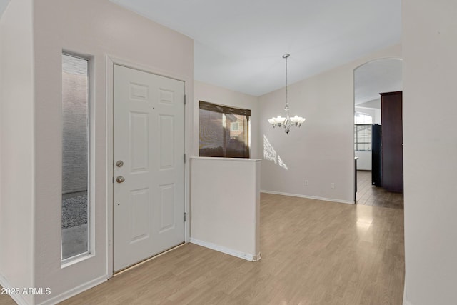 entryway featuring light hardwood / wood-style floors and an inviting chandelier