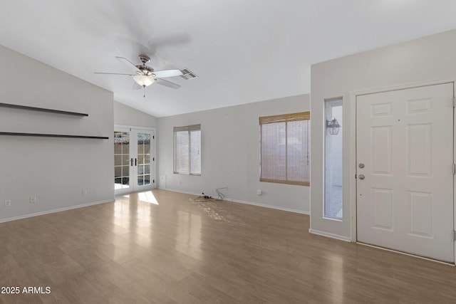 foyer featuring ceiling fan, french doors, hardwood / wood-style floors, and lofted ceiling