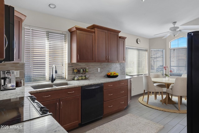 kitchen featuring black appliances, backsplash, ceiling fan, and sink