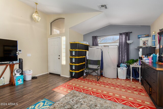 interior space with vaulted ceiling and dark hardwood / wood-style floors