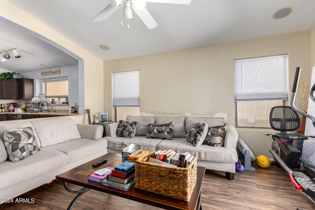 living room featuring wood-type flooring, a healthy amount of sunlight, and ceiling fan