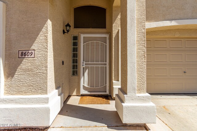 doorway to property with a garage