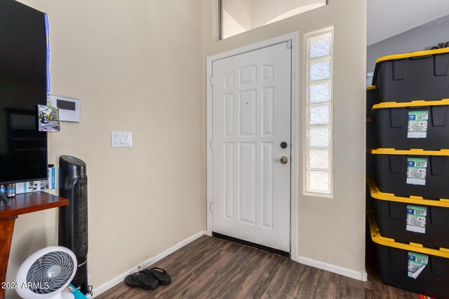 entryway featuring lofted ceiling and dark hardwood / wood-style flooring