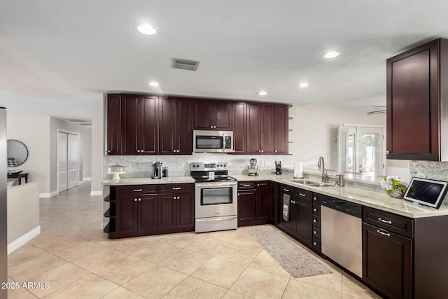 1311 W Ellis St, Mesa, AZ 85201 - kitchen with stainless steel appliances, a sink, open shelves, decorative backsplash, and light tile patterned floors