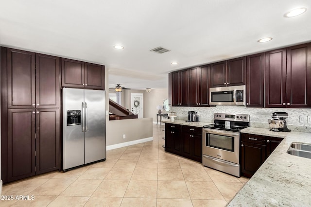 1311 W Ellis St, Mesa, AZ 85201 - kitchen with appliances with stainless steel finishes, light tile patterned floors, recessed lighting, baseboards, and tasteful backsplash