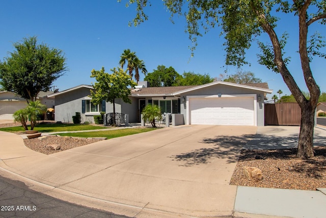 1311 W Ellis St, Mesa, AZ 85201 - ranch-style home featuring stucco siding, an attached garage, and driveway