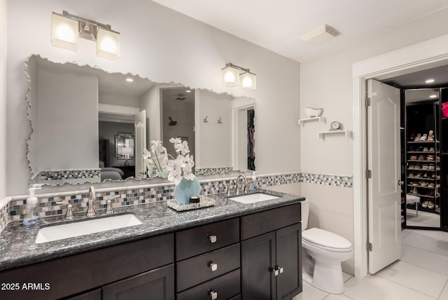 1311 W Ellis St, Mesa, AZ 85201 - ensuite bathroom with tile patterned flooring, toilet, double vanity, a shower, and tile walls