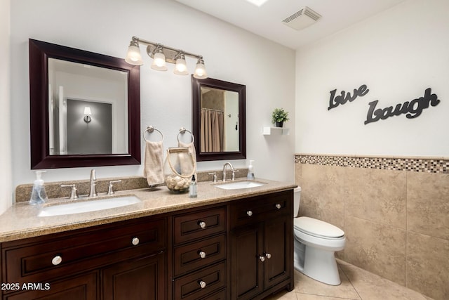 1311 W Ellis St, Mesa, AZ 85201 - full bath with tile patterned floors, toilet, tile walls, and double vanity