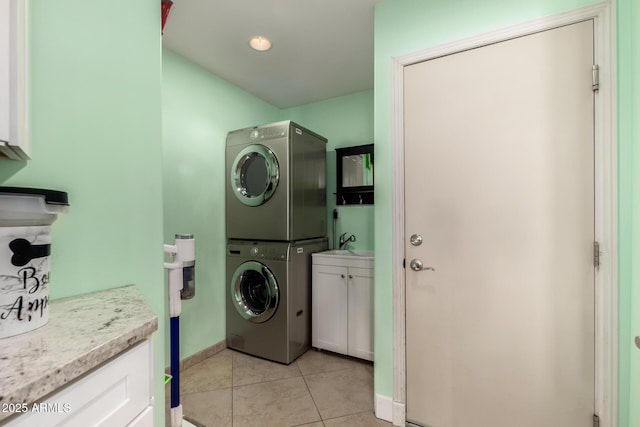 1311 W Ellis St, Mesa, AZ 85201 - laundry room with cabinet space, stacked washer and clothes dryer, light tile patterned flooring, and baseboards