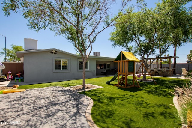 1311 W Ellis St, Mesa, AZ 85201 - back of property featuring a patio area, a playground, stucco siding, and a chimney