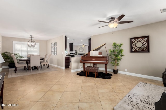 1311 W Ellis St, Mesa, AZ 85201 - living area with light tile patterned floors, a ceiling fan, a chandelier, and baseboards