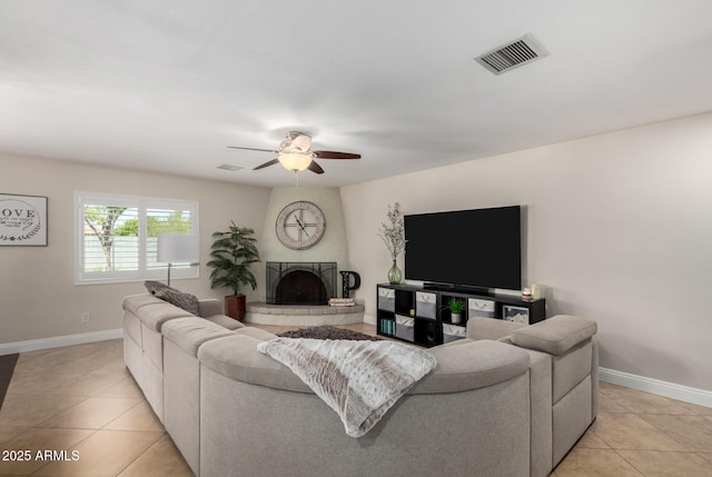 1311 W Ellis St, Mesa, AZ 85201 - living room featuring light tile patterned floors, a ceiling fan, baseboards, and a fireplace with raised hearth