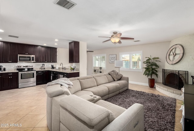 1311 W Ellis St, Mesa, AZ 85201 - living area featuring a ceiling fan, recessed lighting, light tile patterned flooring, and a fireplace
