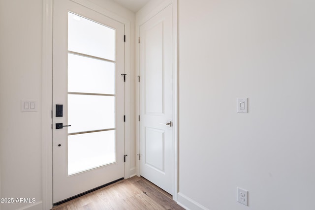 doorway to outside with light wood-style flooring