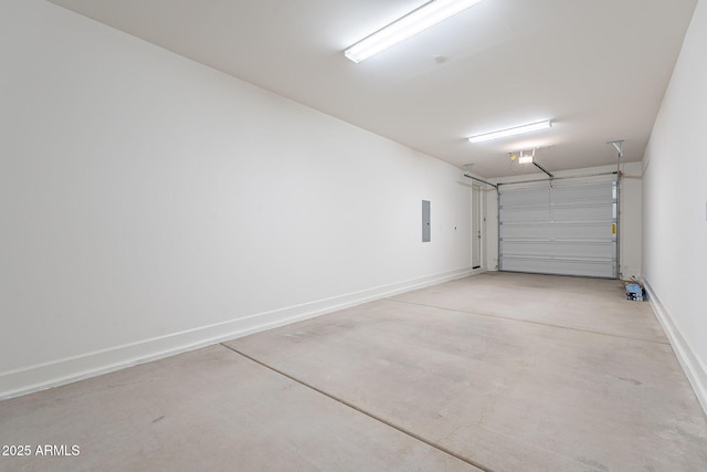 garage with a garage door opener, electric panel, and baseboards