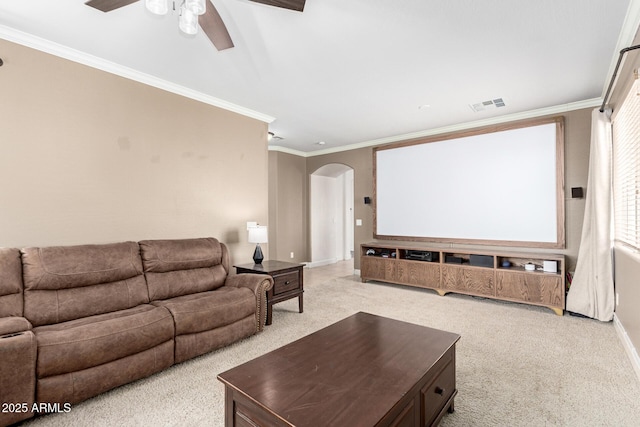 157 N 110th Ave, Avondale, AZ 85323 - cinema room featuring arched walkways, ceiling fan, light carpet, baseboards, and ornamental molding
