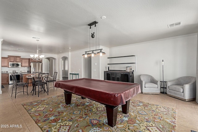 157 N 110th Ave, Avondale, AZ 85323 - rec room with light tile patterned floors, billiards, crown molding, a chandelier, and arched walkways